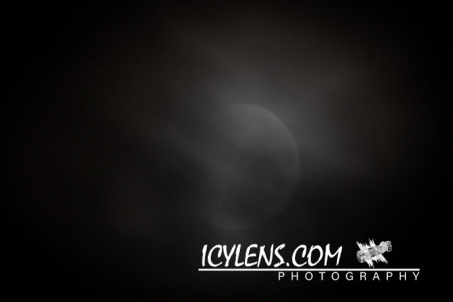 The moon behind the clouds